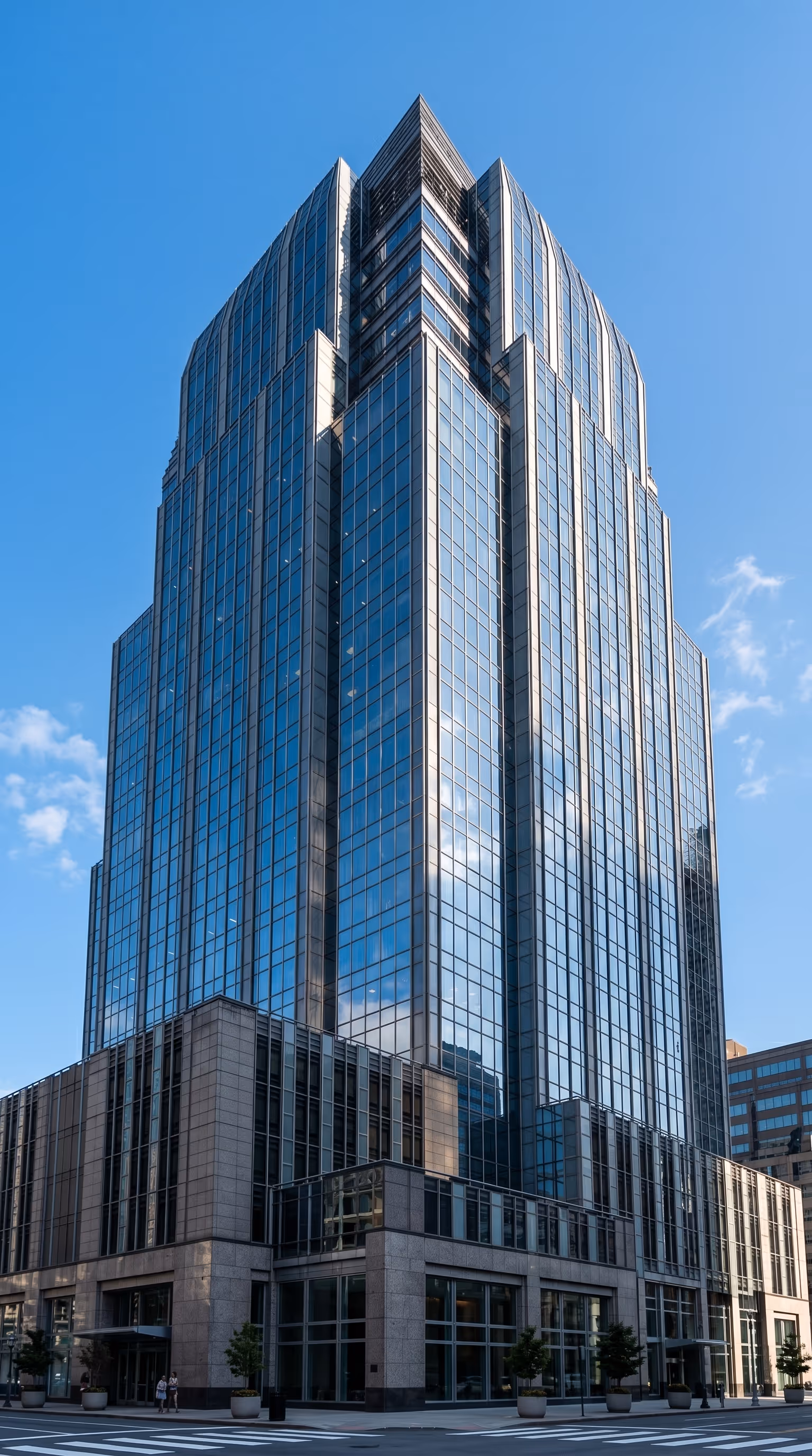 Glass office tower in a city skyline representing the urban context around Pease Park Conservancy's park operations in Austin, Texas