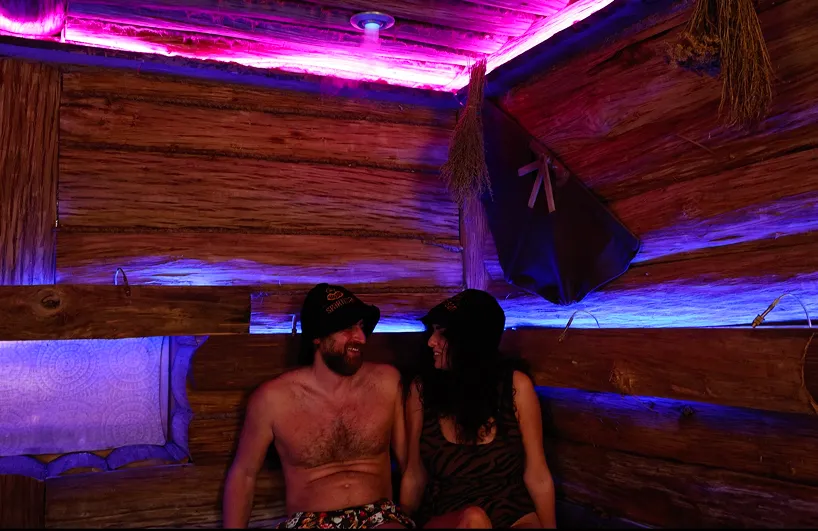 Two guests relaxing together in the wooden sauna at SPArtisan Budapest.