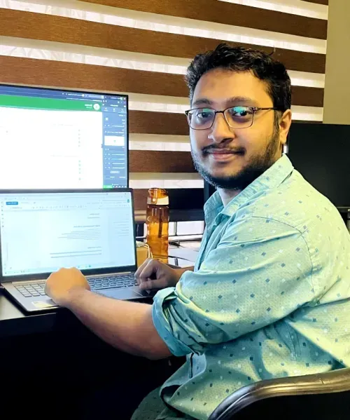 a man sitting at a desk in front of a computer