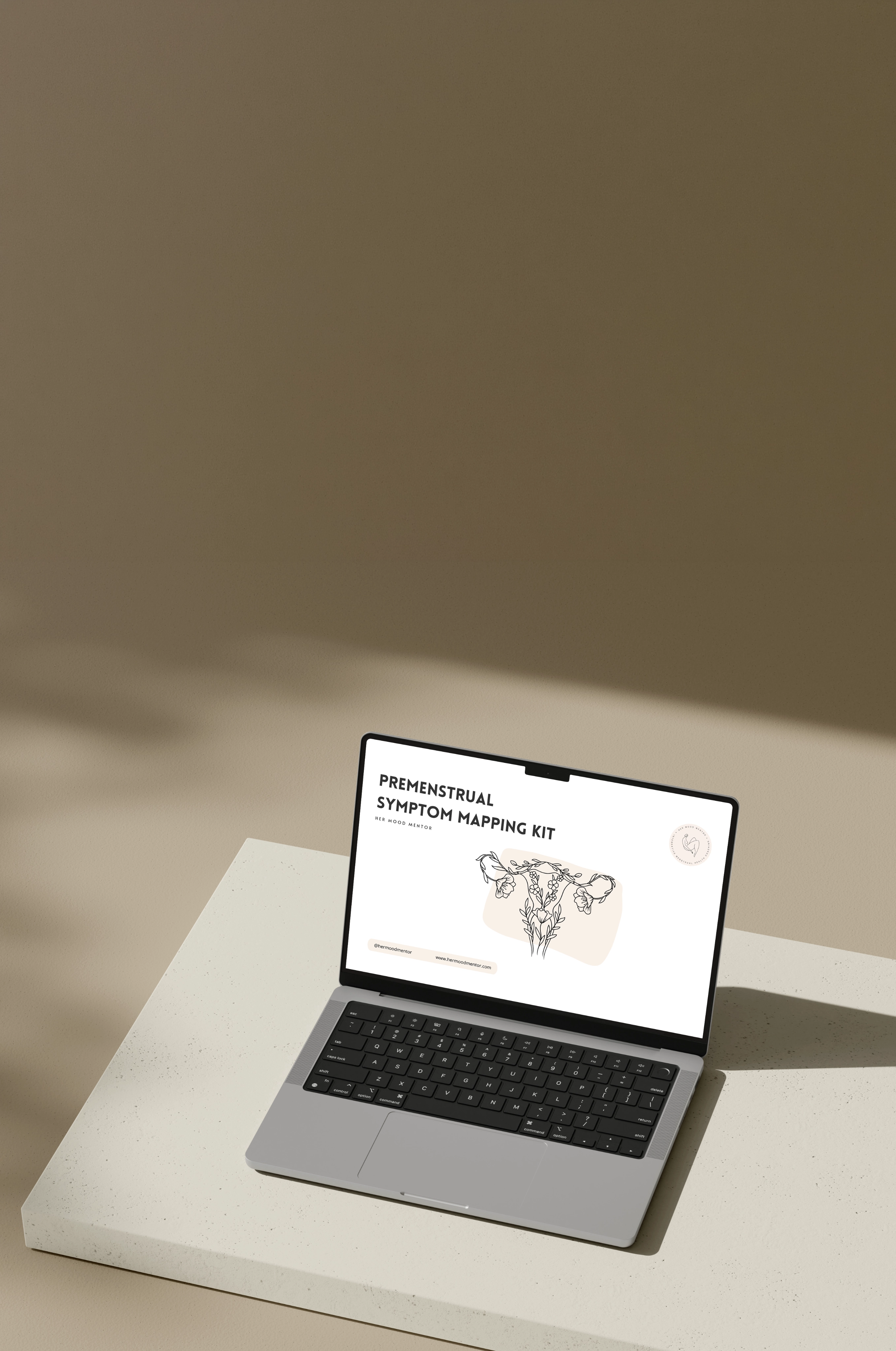 Laptop on a beige surface displaying a webpage titled 'Premenstrual Symptom Mapping Kit' with a floral uterus illustration.