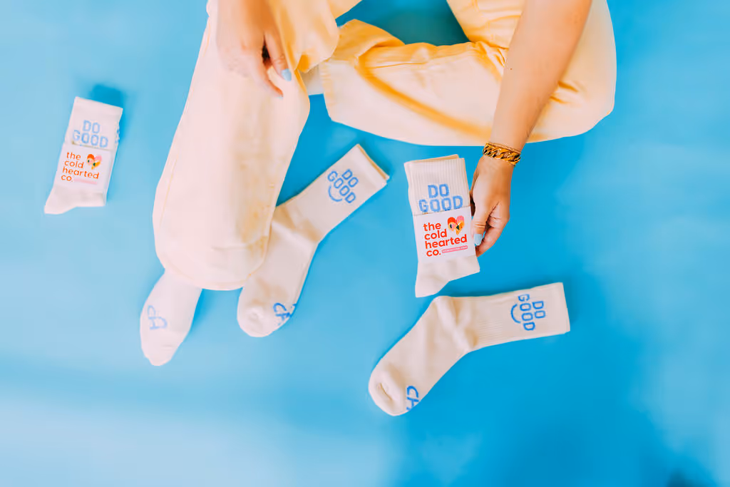 Custom socks that say "do good" on them.