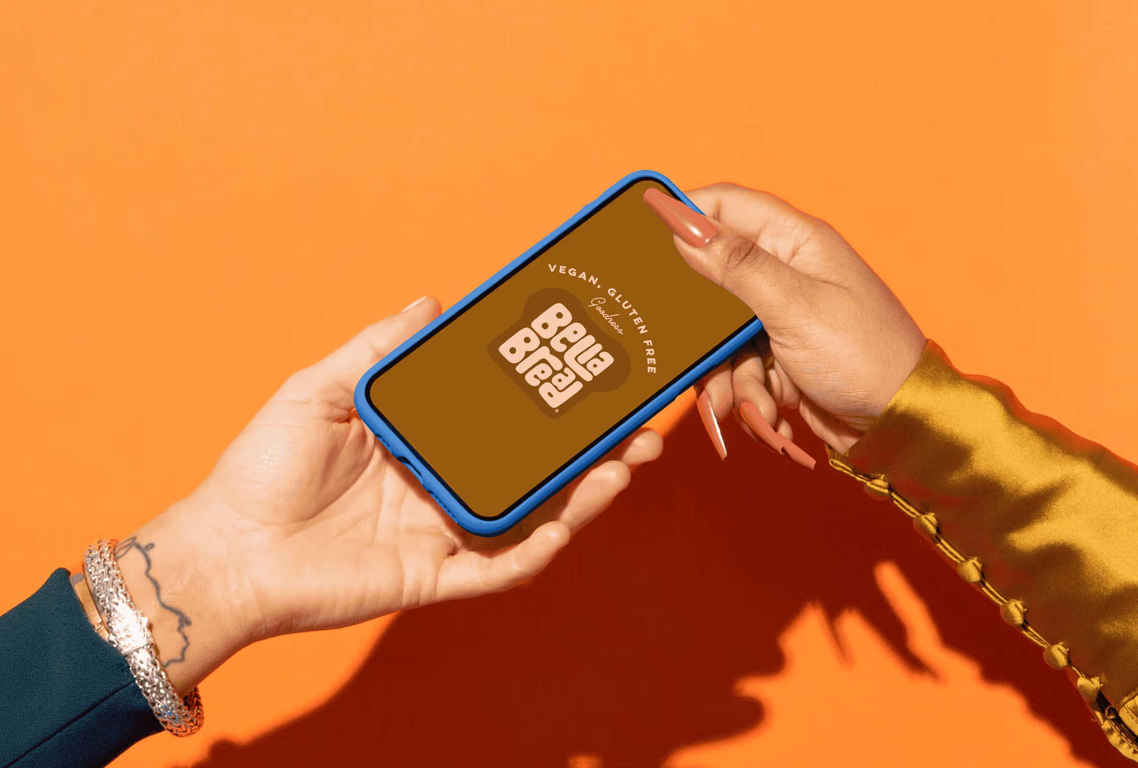 Holding a phone that shows a custom logo design for Bella Bread