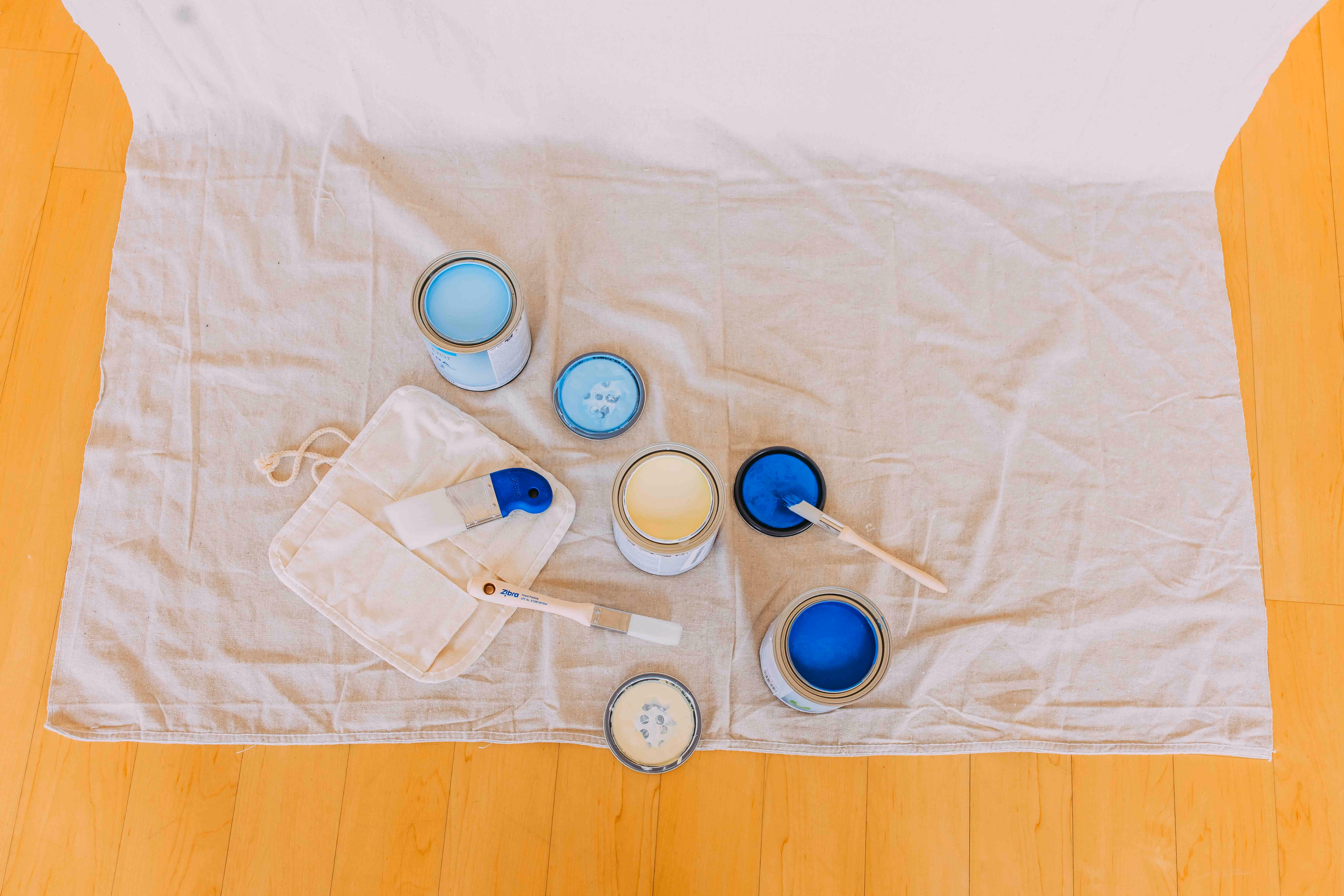 Paint cans used for painting a custom mural artwork design in a business