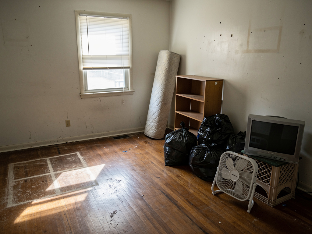 Living room mid-cleanout with junk staged for removal in Columbus OH