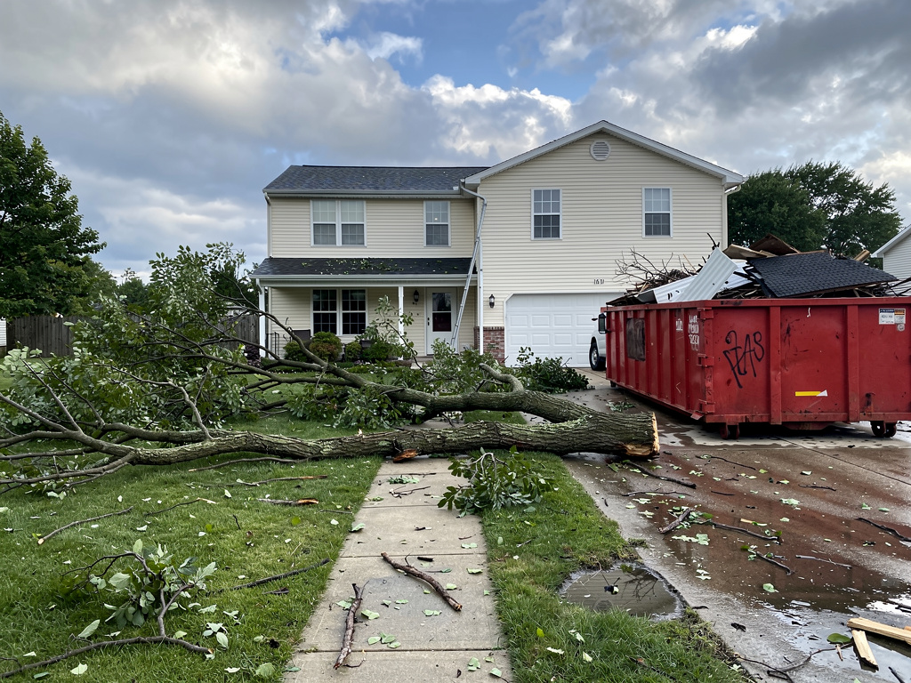 Storm debris scattered across suburban front yard after thunderstorm in central Ohio