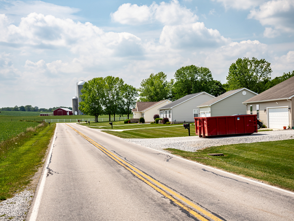 Johnstown Ohio rural road with homes and red dumpster - Donkey Dumpster junk removal service area
