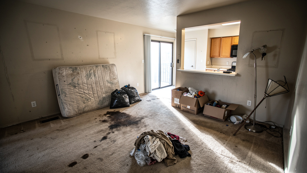 Apartment unit with left-behind tenant belongings ready for cleanout