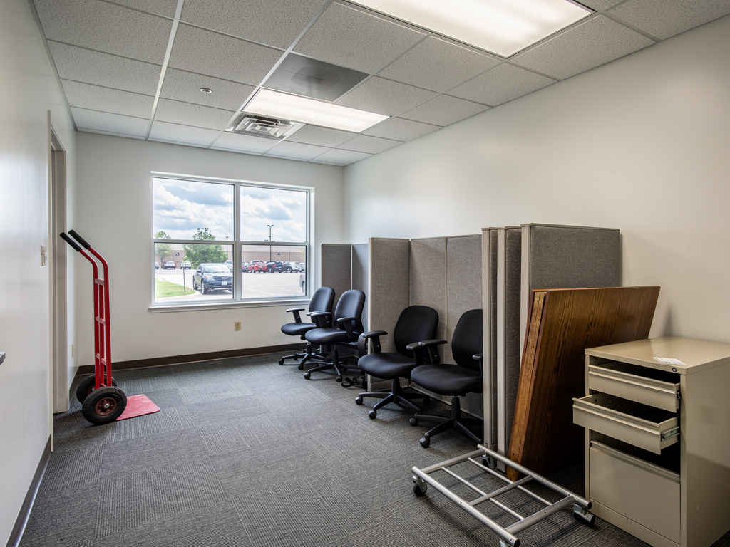 Office suite being cleared with stacked cubicle panels
