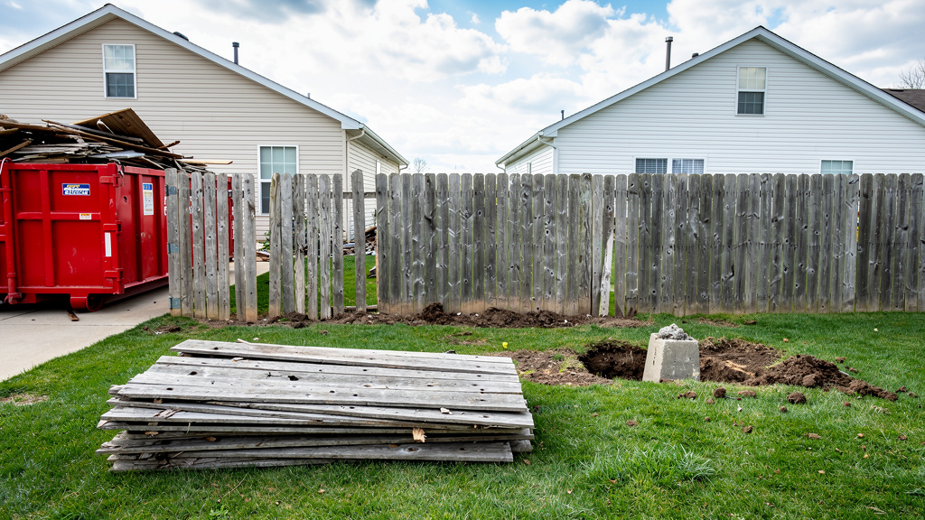 Old fence being removed along property line in Columbus Ohio