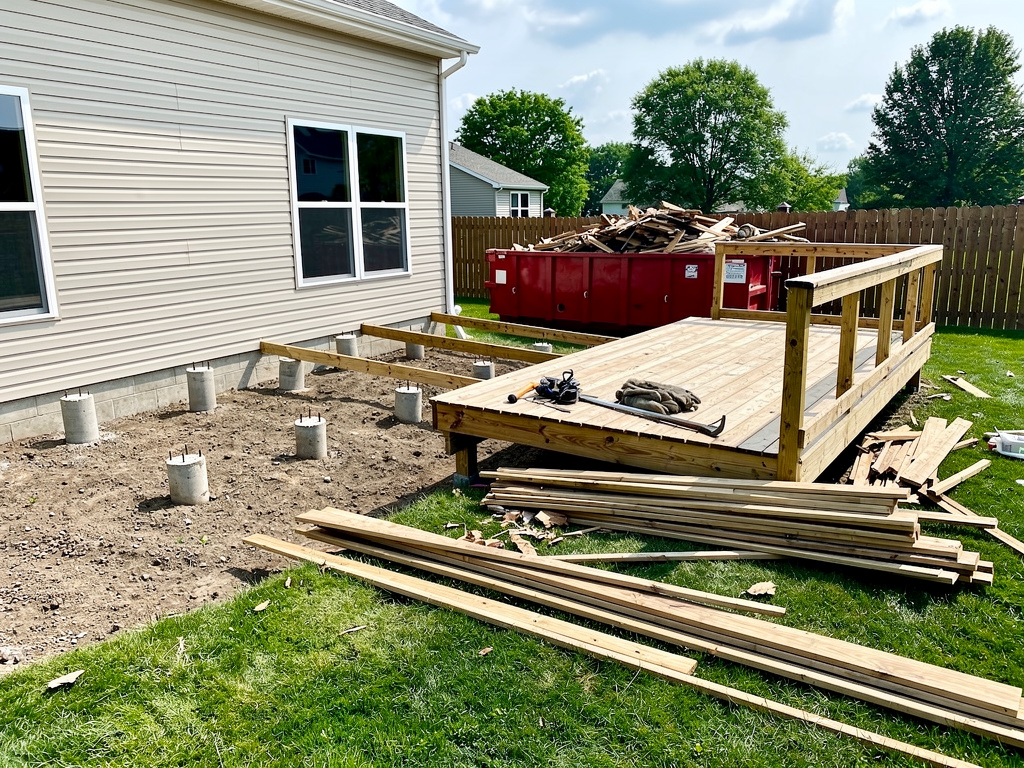 Deck demolition in progress in suburban backyard