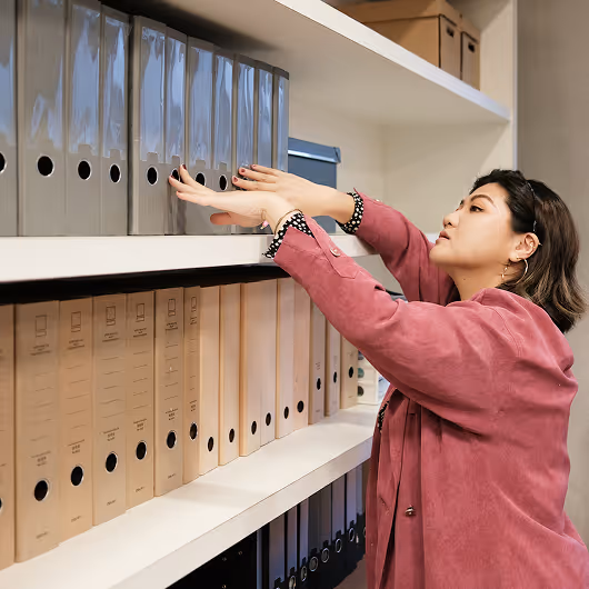Woman with files of pipe inspection data