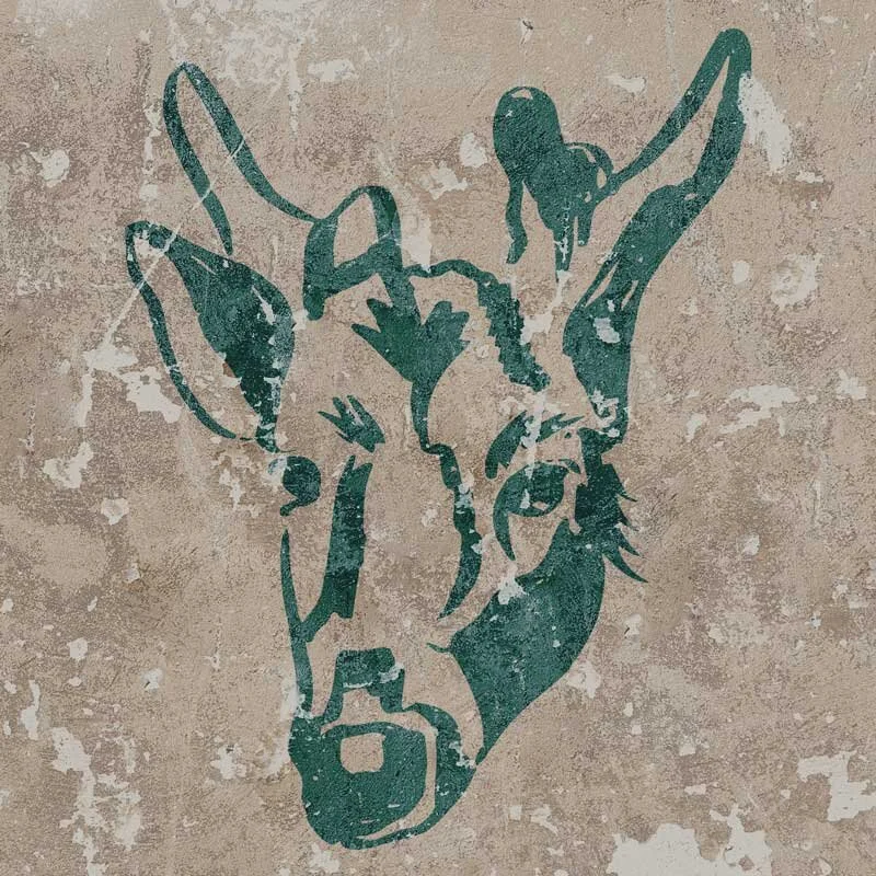 Weathered stencil art of the deer, Geronimo, face painted in dark green on a textured beige wall.