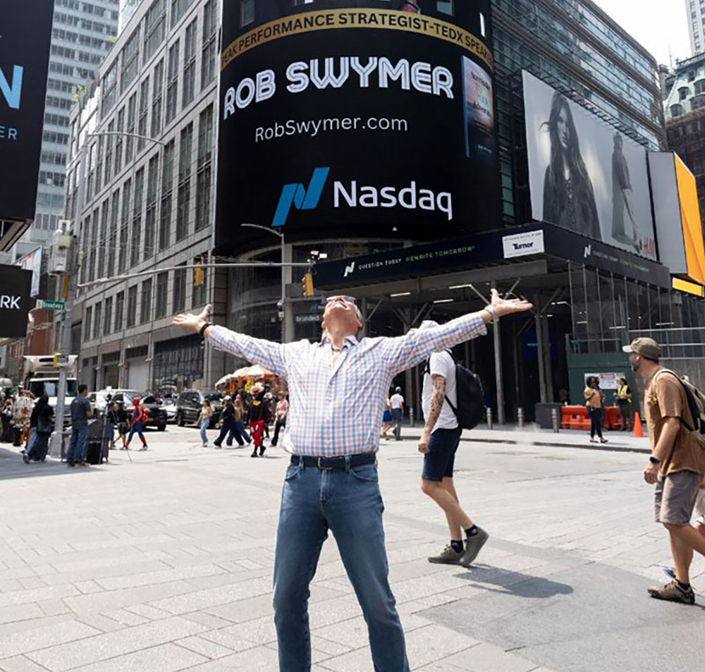 Rob Swymer in front of Nasdaq billboard on Time Square