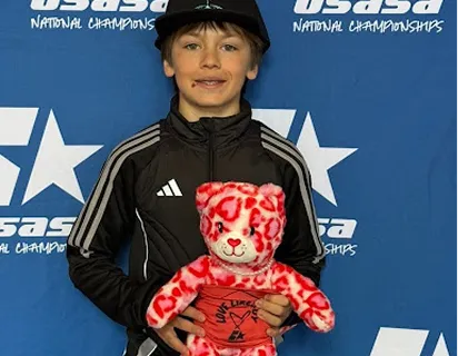 Young athlete competing at a USASA snowboard event