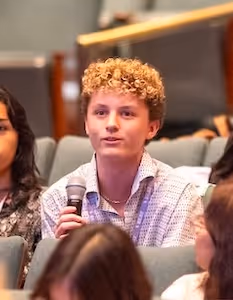 SEAT Advocacy Day participant asking a question with a microphone