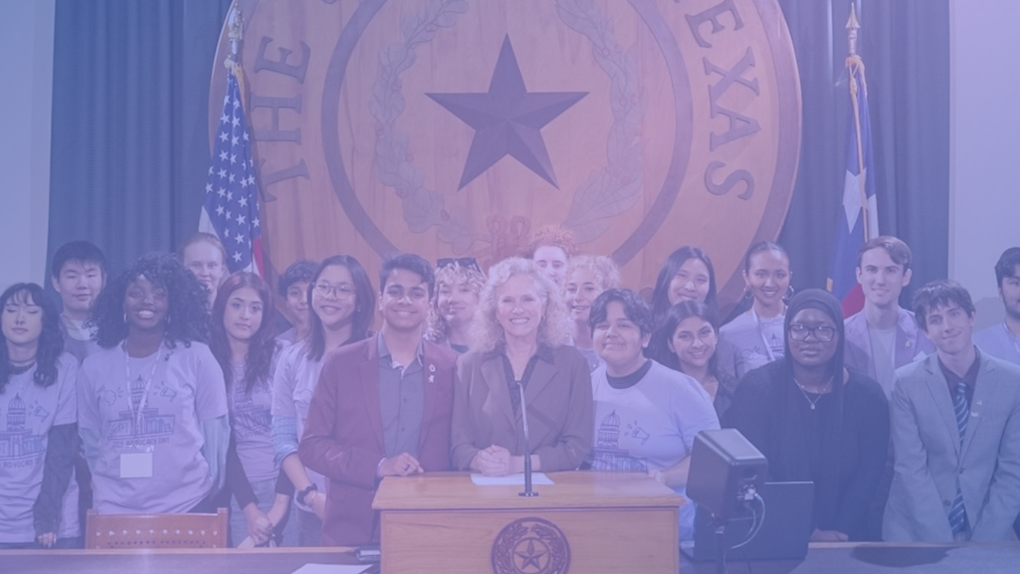 Group of diverse young people and a woman standing behind a podium in front of a large Texas state seal with flags in the background.