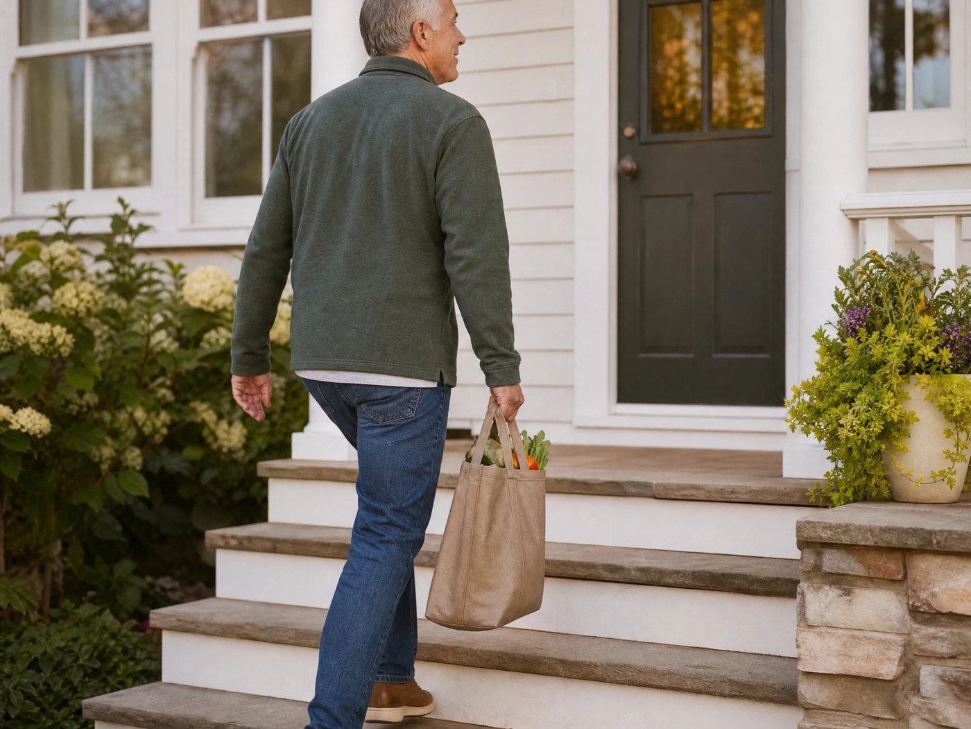 Customer carrying groceries up the front steps