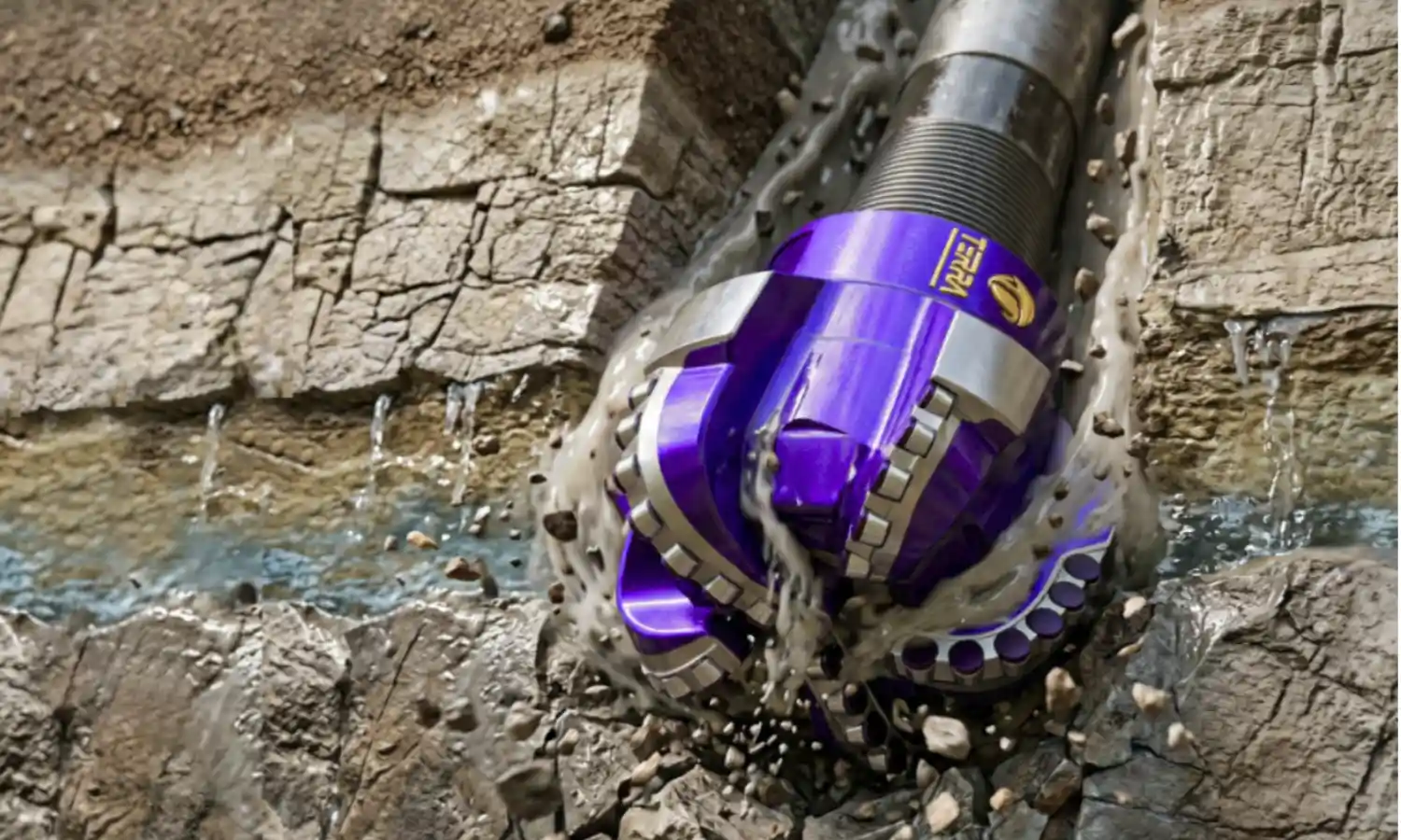 TERRA tricone drill bits in metallic purple finish stacked on pallet, premium HDD rock drilling tools