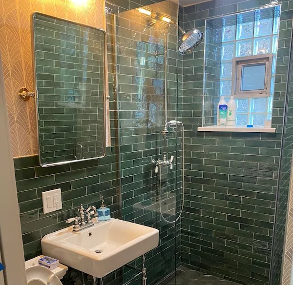 Green subway tile bathroom by Wood Contracting