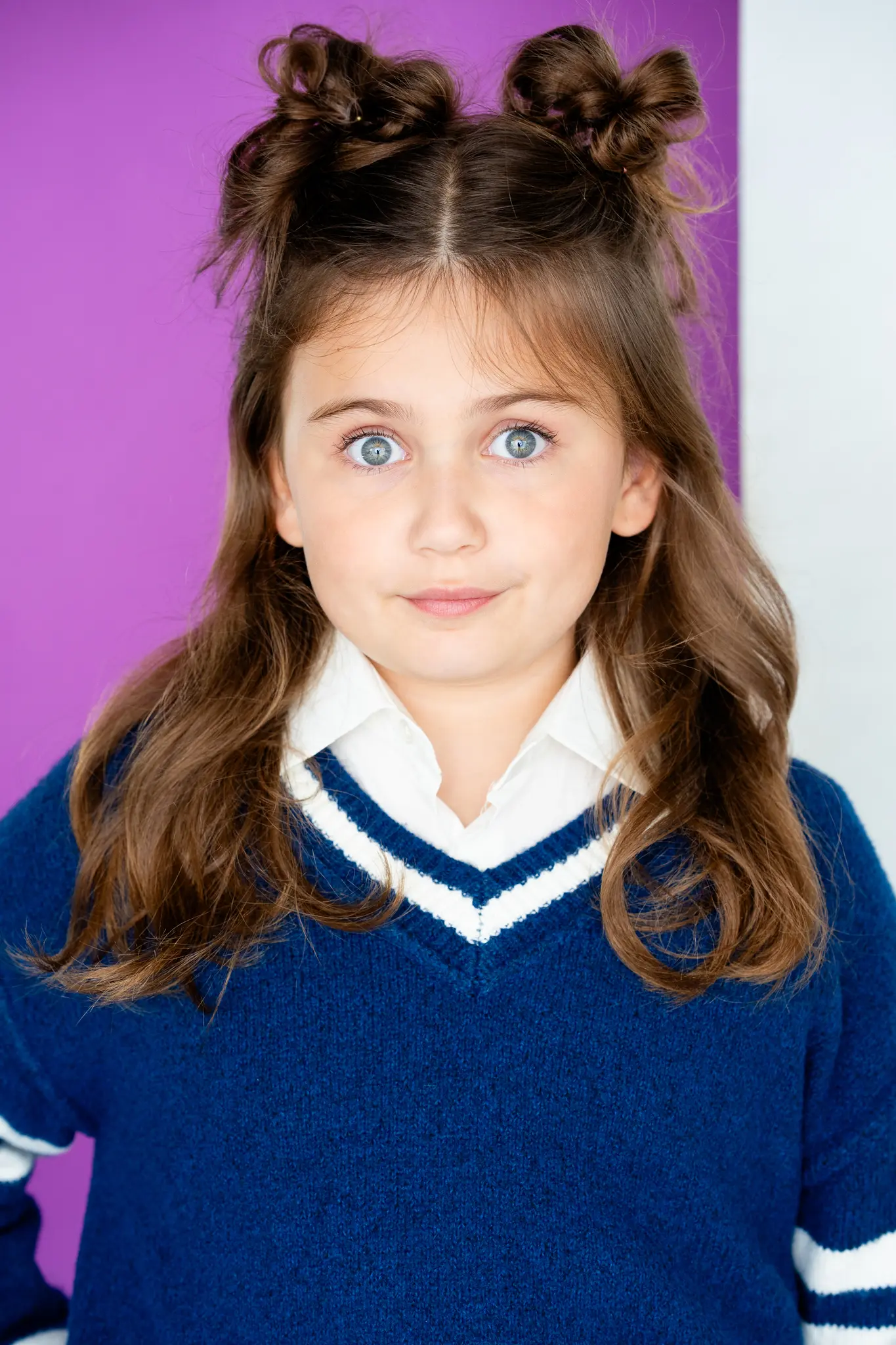 Caroline Brauner studio portrait with character styling against purple background