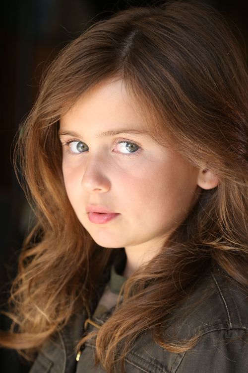 Close-up portrait of Caroline Brauner with long light brown hair and gray eyes wearing a dark jacket.