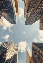 Person mopping a shiny floor near large windows with city view in the background.
