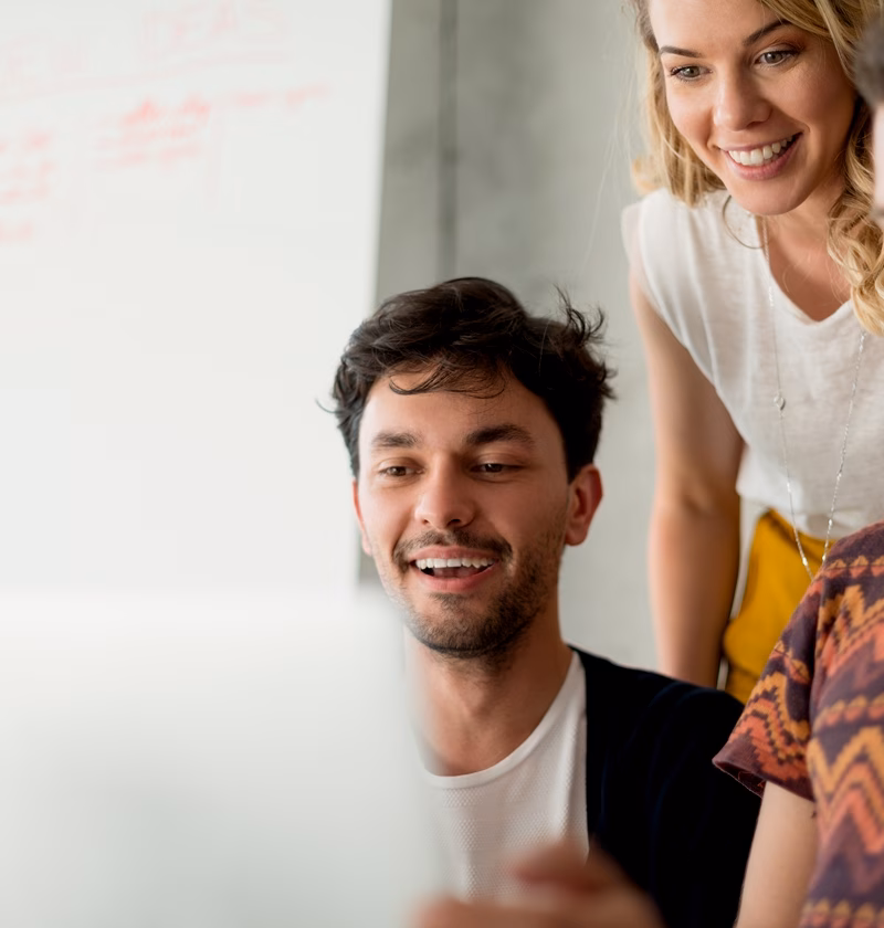 a group of people looking at a computer screen