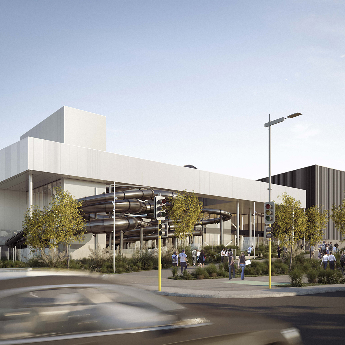 Modern building with outdoor black twisting slides and people walking near traffic lights.