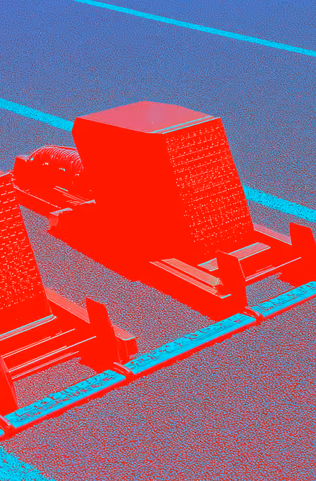 Bloc de départ rouge et bleu illustrant l’usage de l’IA comme point de lancement créatif.