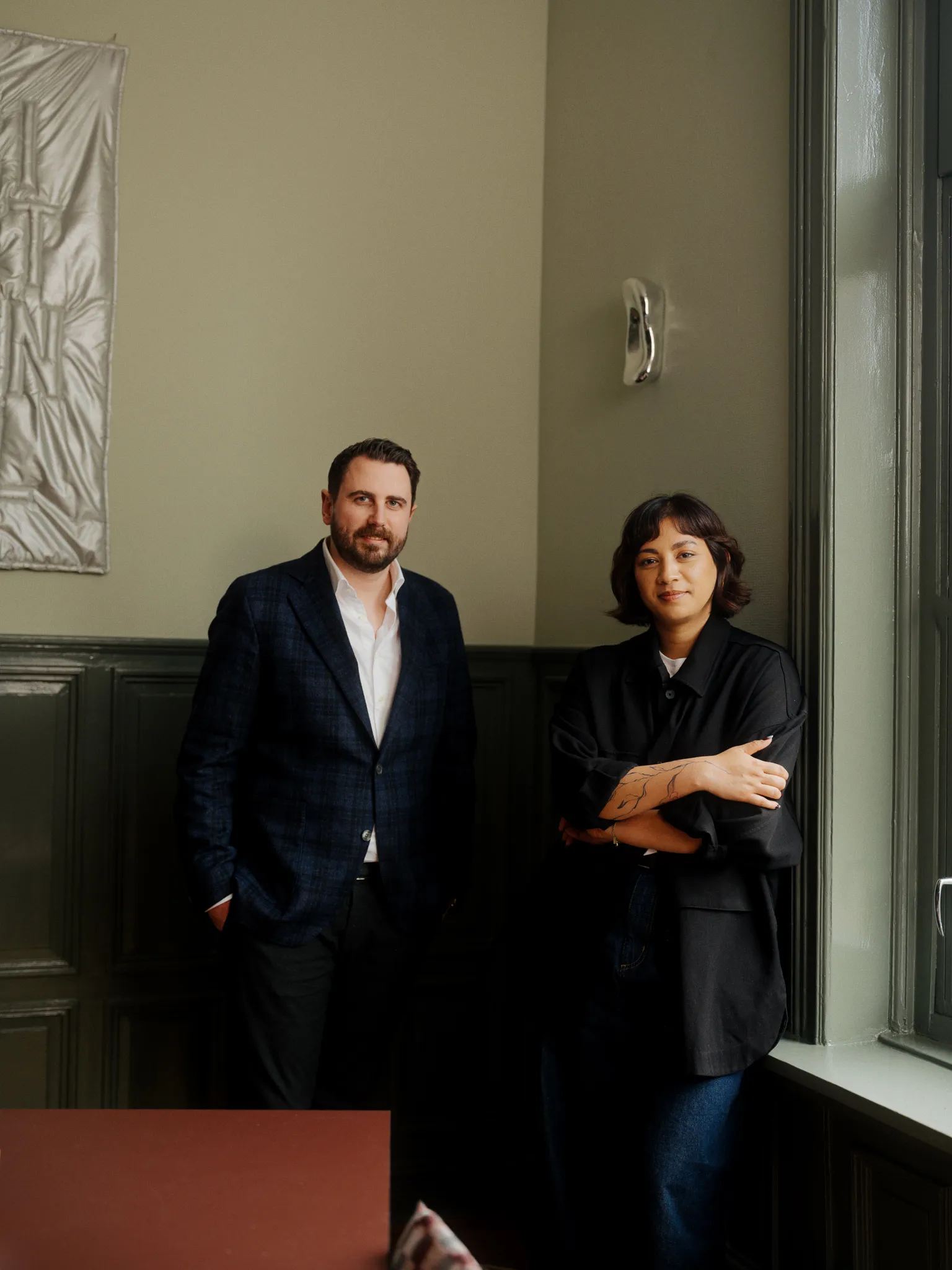 Portrait of two Dagger senior consultants standing in a professional office setting.