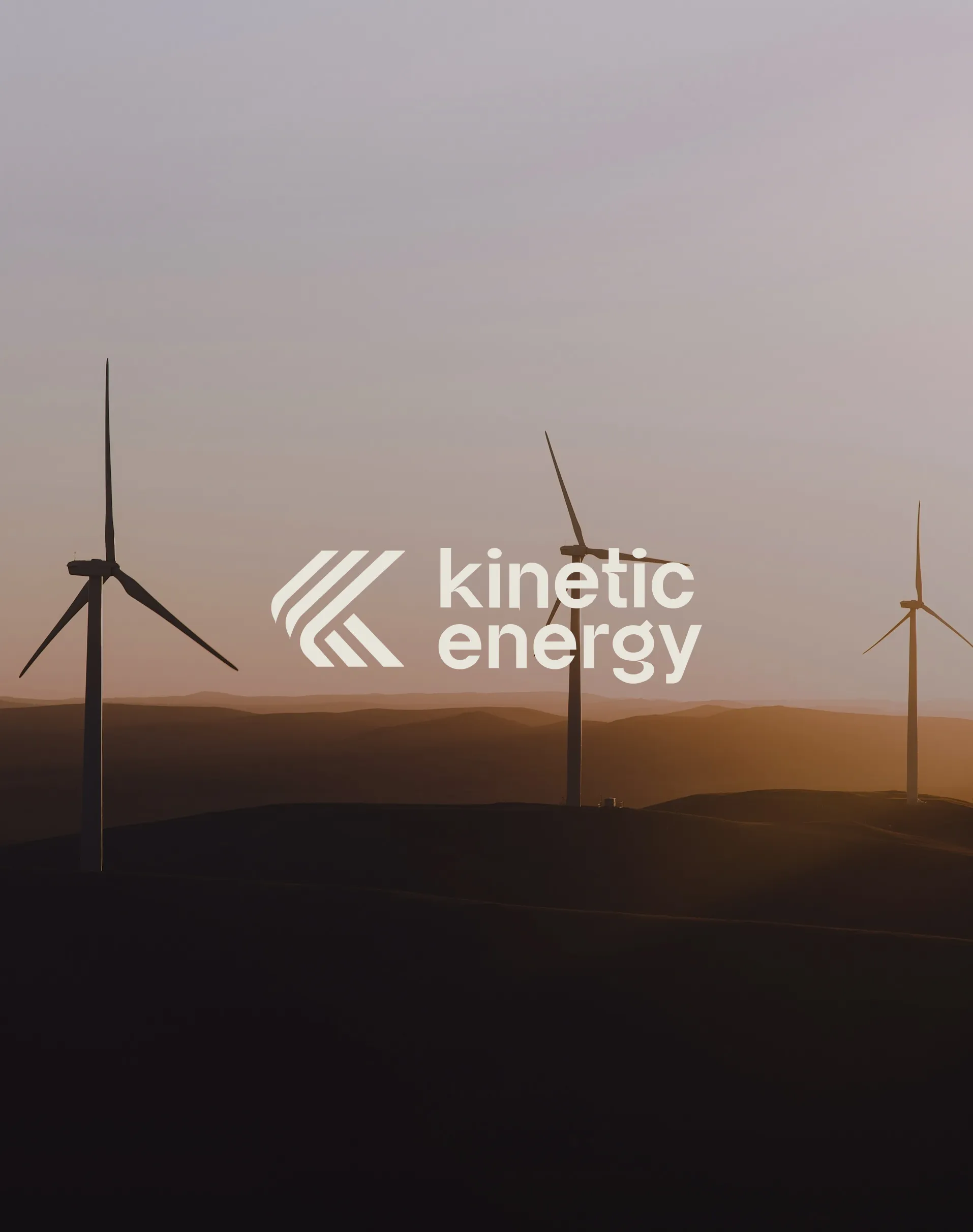 Wind turbines at sunset with the Kinetic Energy brand logo.