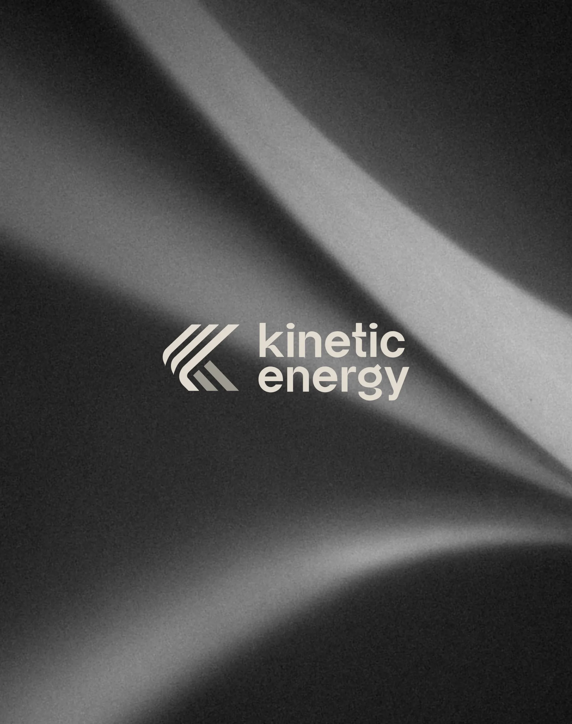 Kinetic Energy logo on a black textured fabric background.