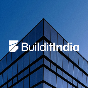 Modern glass building corner with blue sky background and BuilditIndia logo in white text.
