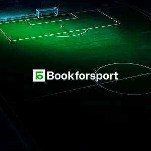 Illuminated soccer field at night with the Bookforsport logo and text in the center.