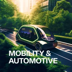 Futuristic autonomous electric vehicle driving on a road surrounded by green trees with 'MOBILITY & AUTOMOTIVE' text.