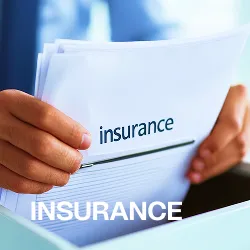 Person holding insurance documents with the word 'insurance' visible on the papers.