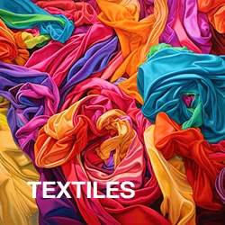 Vibrant multicolored fabrics arranged in swirling folds with the word 'TEXTILES' in white.