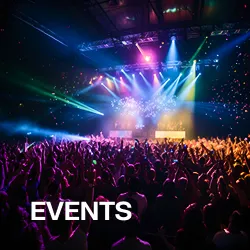Crowd enjoying a colorful live concert with vibrant stage lights and confetti.