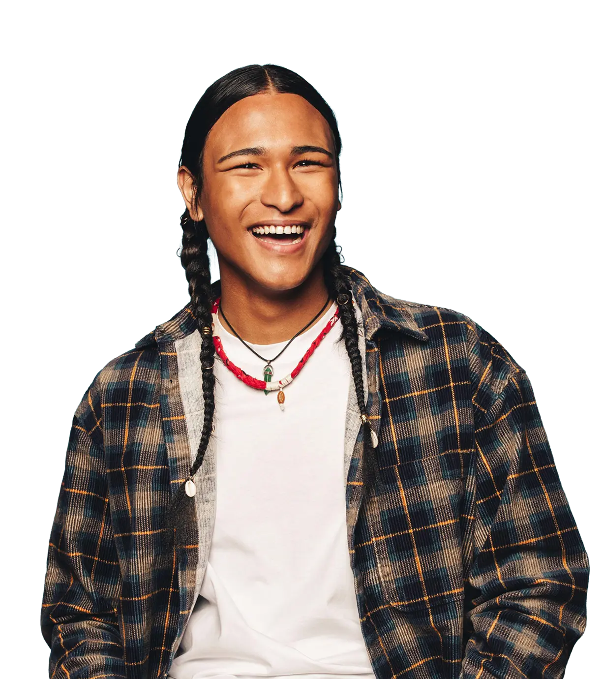 Smiling young person with long braided hair wearing a plaid shirt over a white t-shirt and two necklaces.