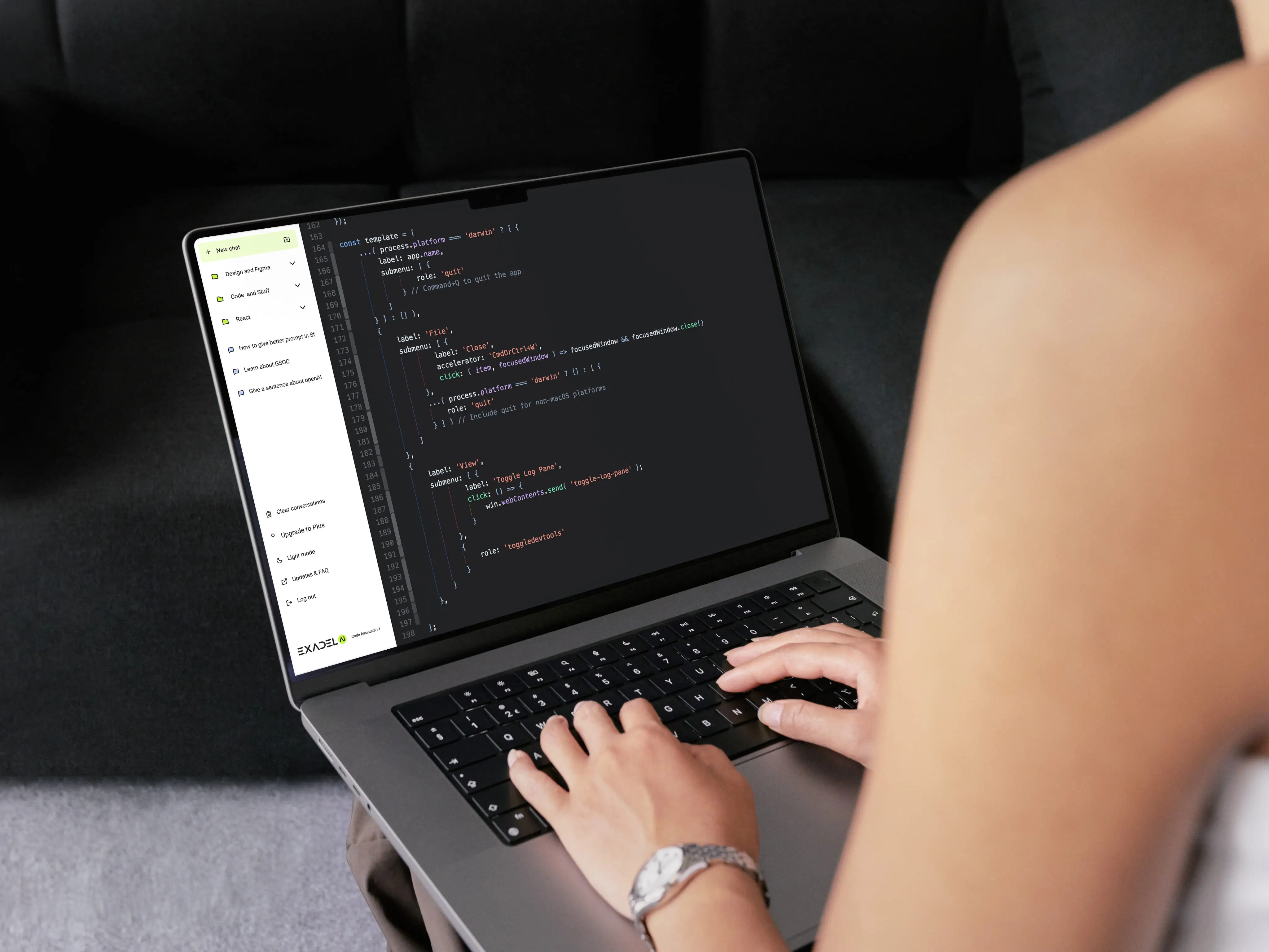 Two people sitting at a table with a laptop.