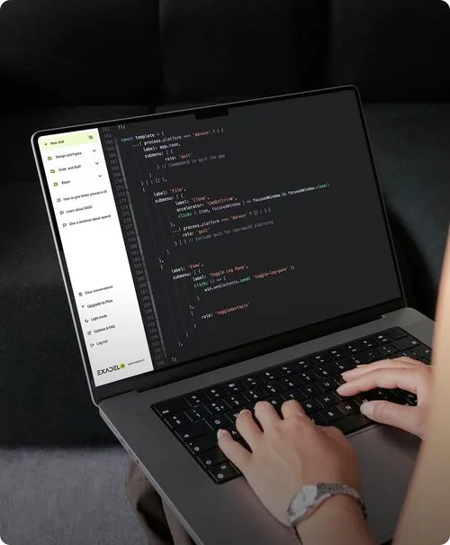 Two people sitting at a table with a laptop.