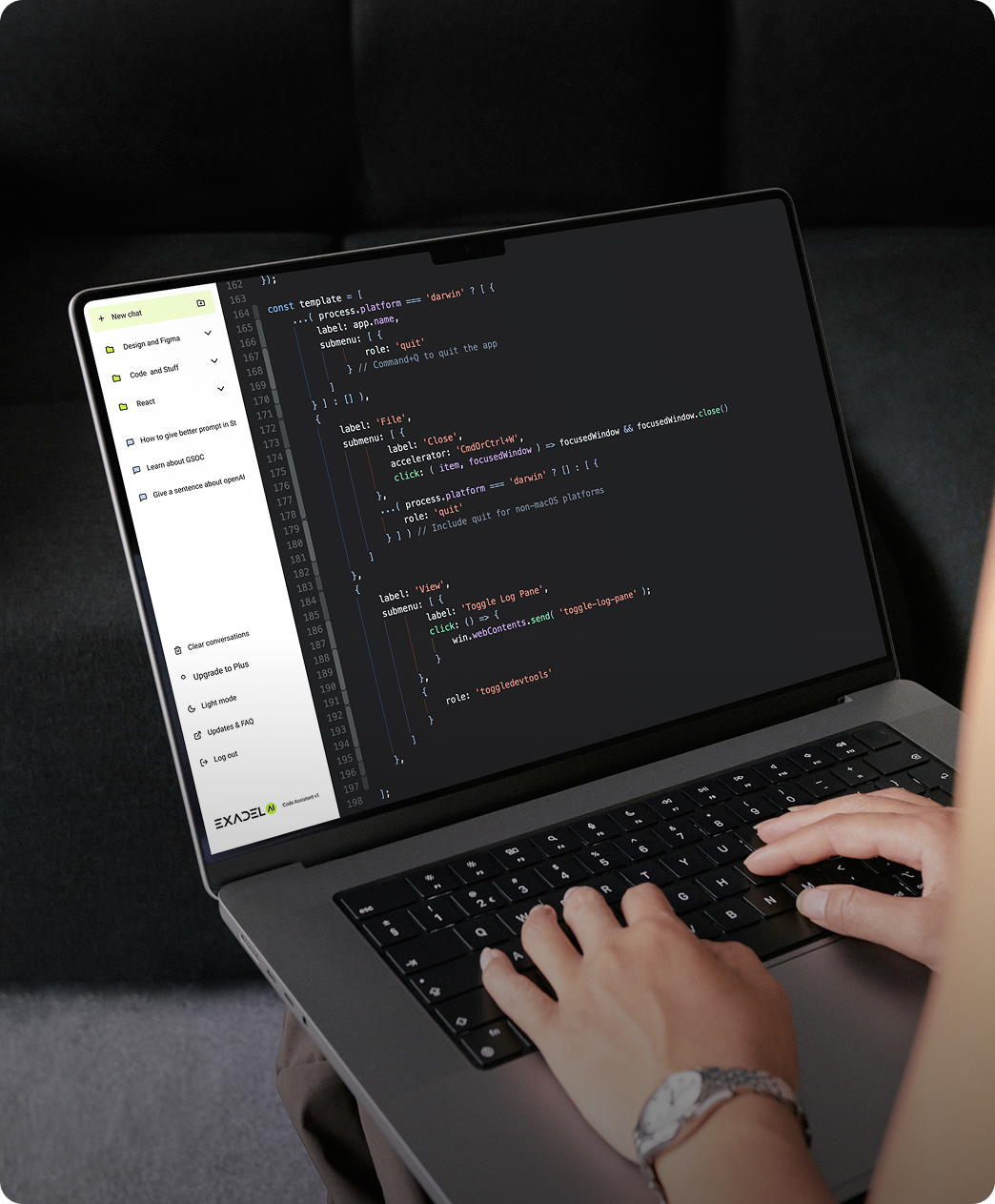 Two people sitting at a table with a laptop.