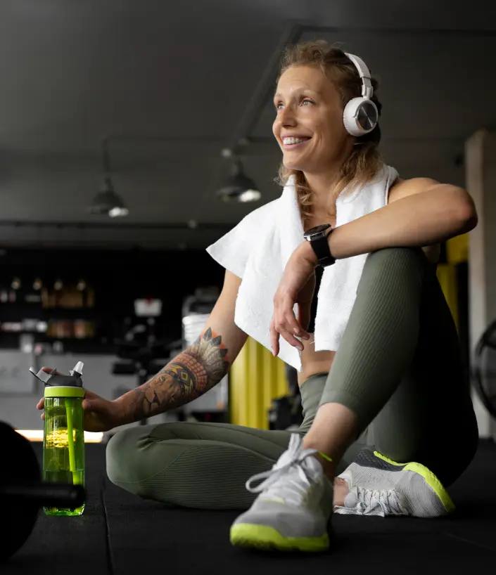 Two people sitting at a table with a laptop.
