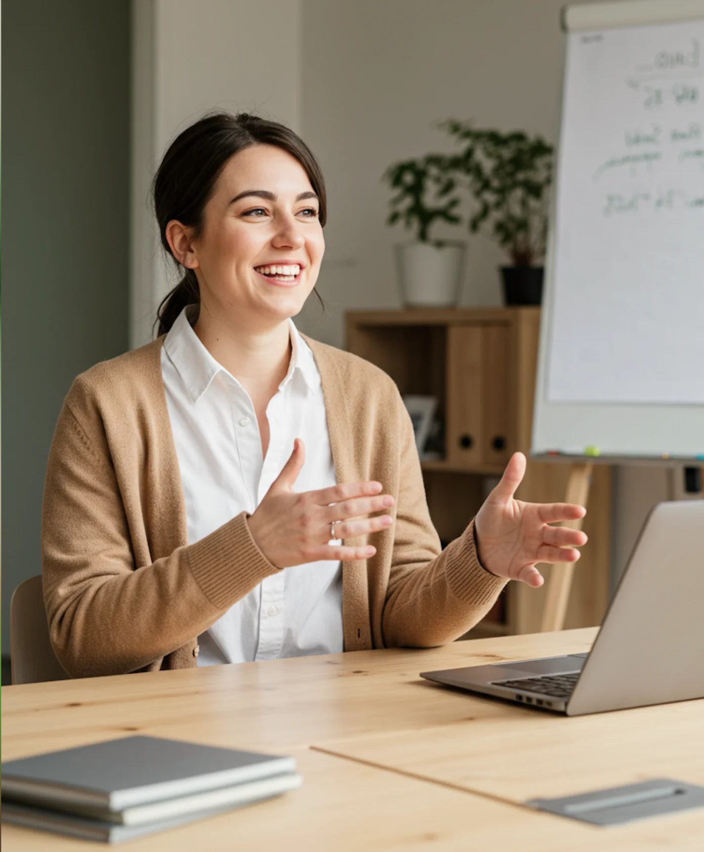 Two people sitting at a table with a laptop.