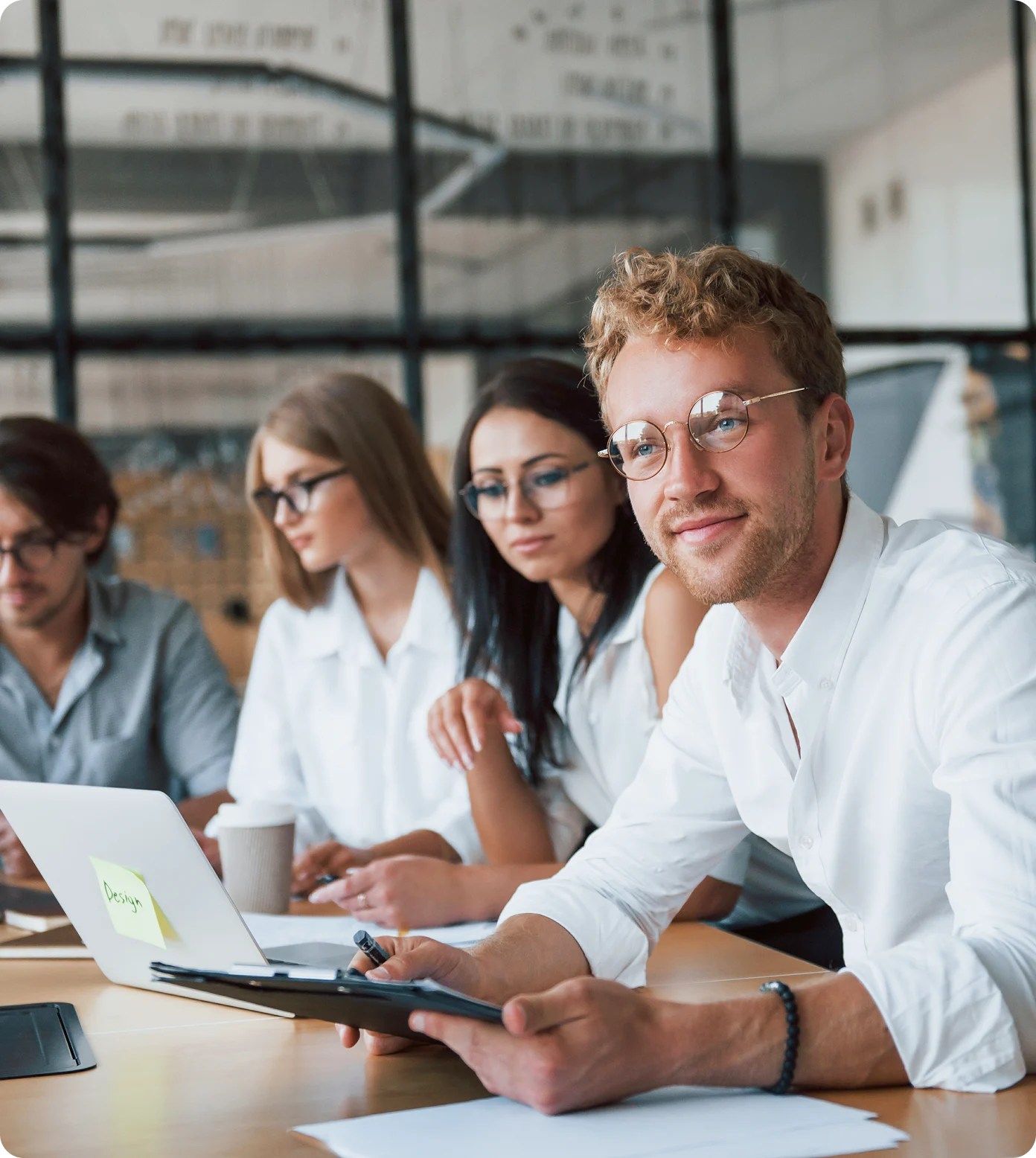 Two people sitting at a table with a laptop.
