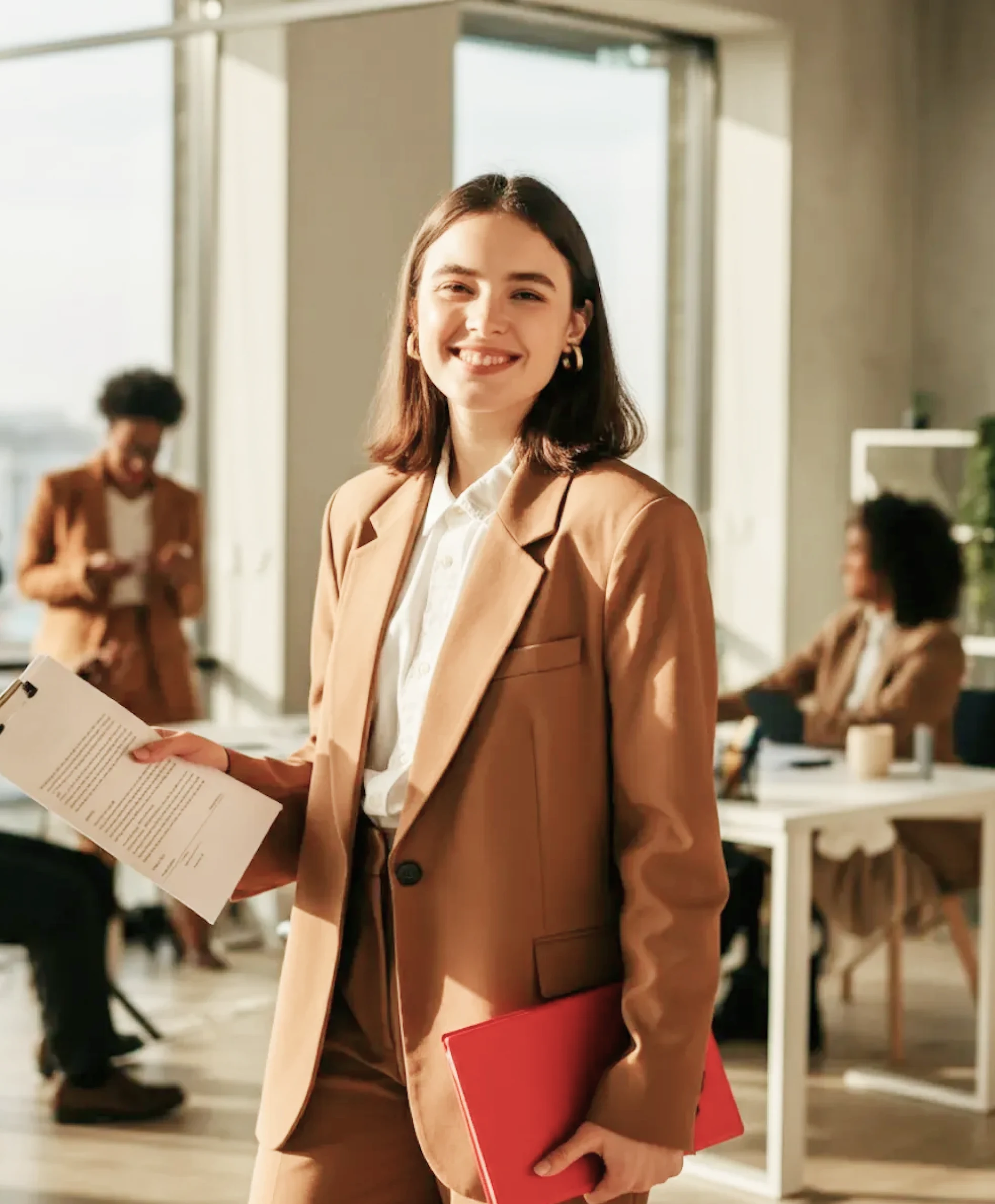 Two people sitting at a table with a laptop.