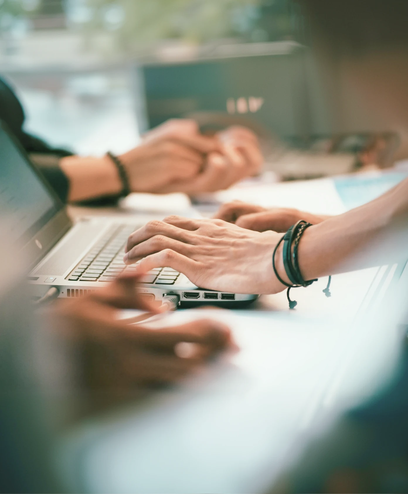 Two people sitting at a table with a laptop.
