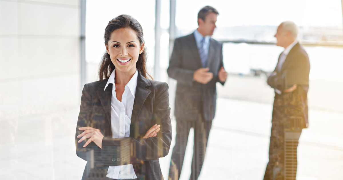 Two people sitting at a table with a laptop.