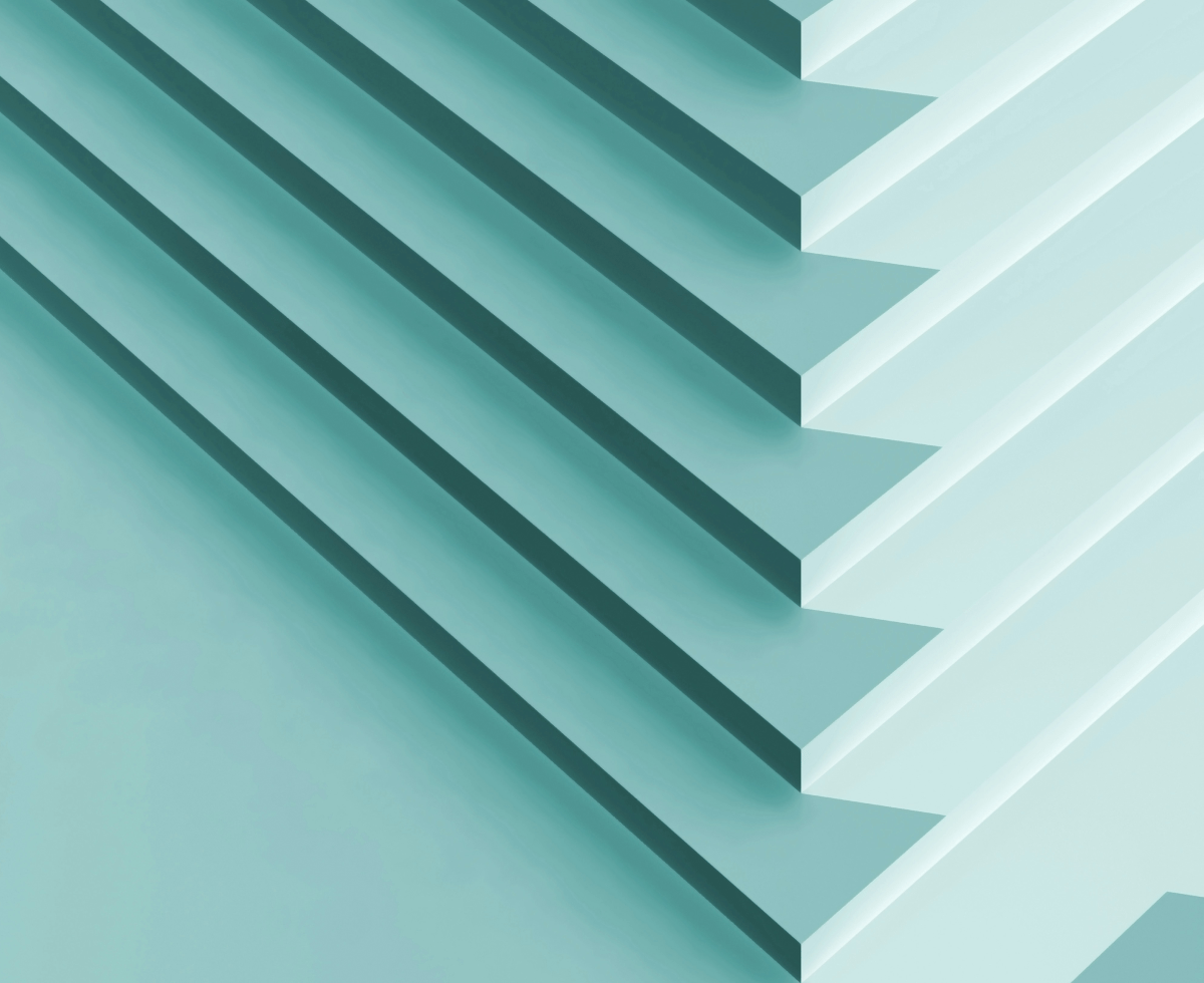 Two people sitting at a table with a laptop.