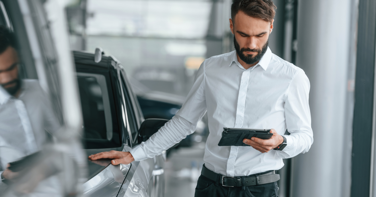 Two people sitting at a table with a laptop.